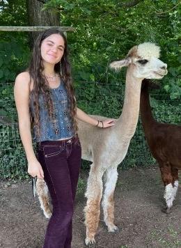 abigail gross poses with a llama