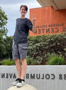 portrait of ren standing in front of a building at claremont mckenna college